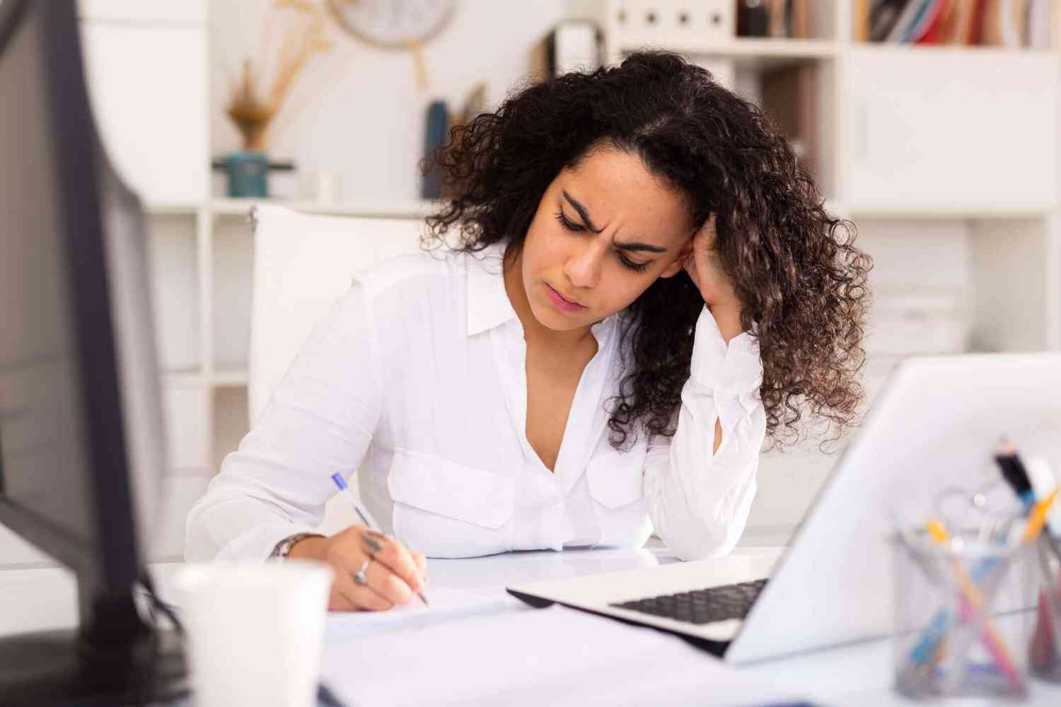 stressed woman looking at finances