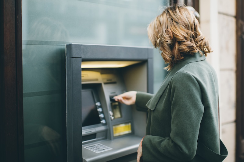 woman using an ATM machine